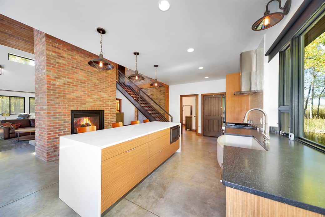 cozy up at the kitchen island next to the fireplace 