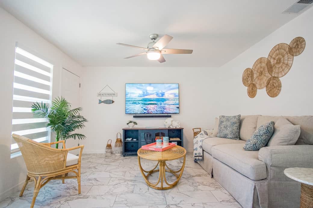 Bright, airy living room with a comfy sofa bed, smart TV, and coastal-modern touches. Bright, airy living room with a comfy sofa bed, smart TV, and coastal-modern touches.
