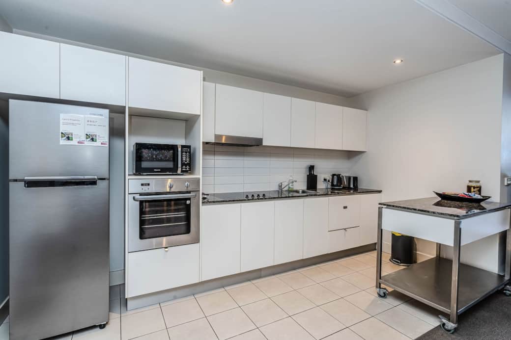 Our modern kitchen is equipped with everything you need to create culinary delights. The stainless steel appliances, including a refrigerator, oven, and microwave, are ready for your cooking . The  countertop and island provide ample room for meal.