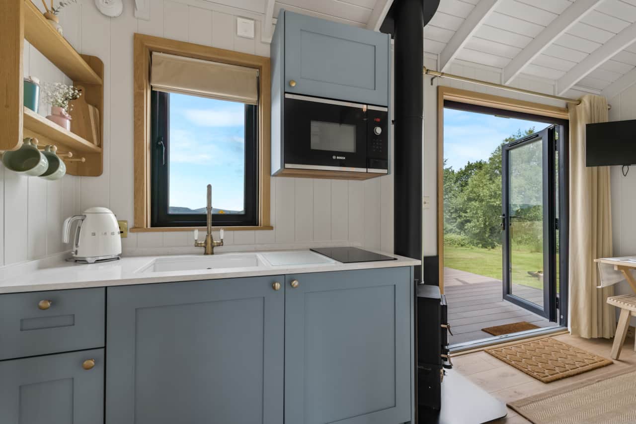 Kitchen with hob, microwave, kettle, toaster and fridge