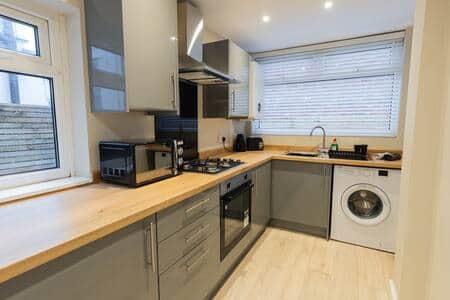 Kitchen area with all appliances required 