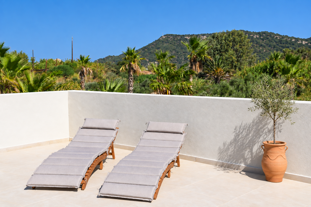 Private rooftop terrace with sun loungers and hillside views at Villa Pastida II, Rhodes.