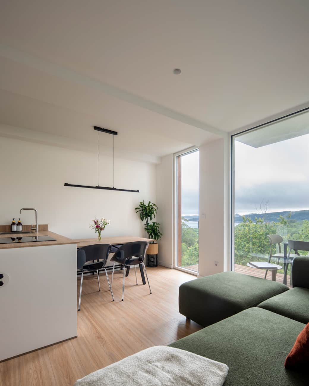 Open living space, modern kitchen, and green views for a peaceful stay.