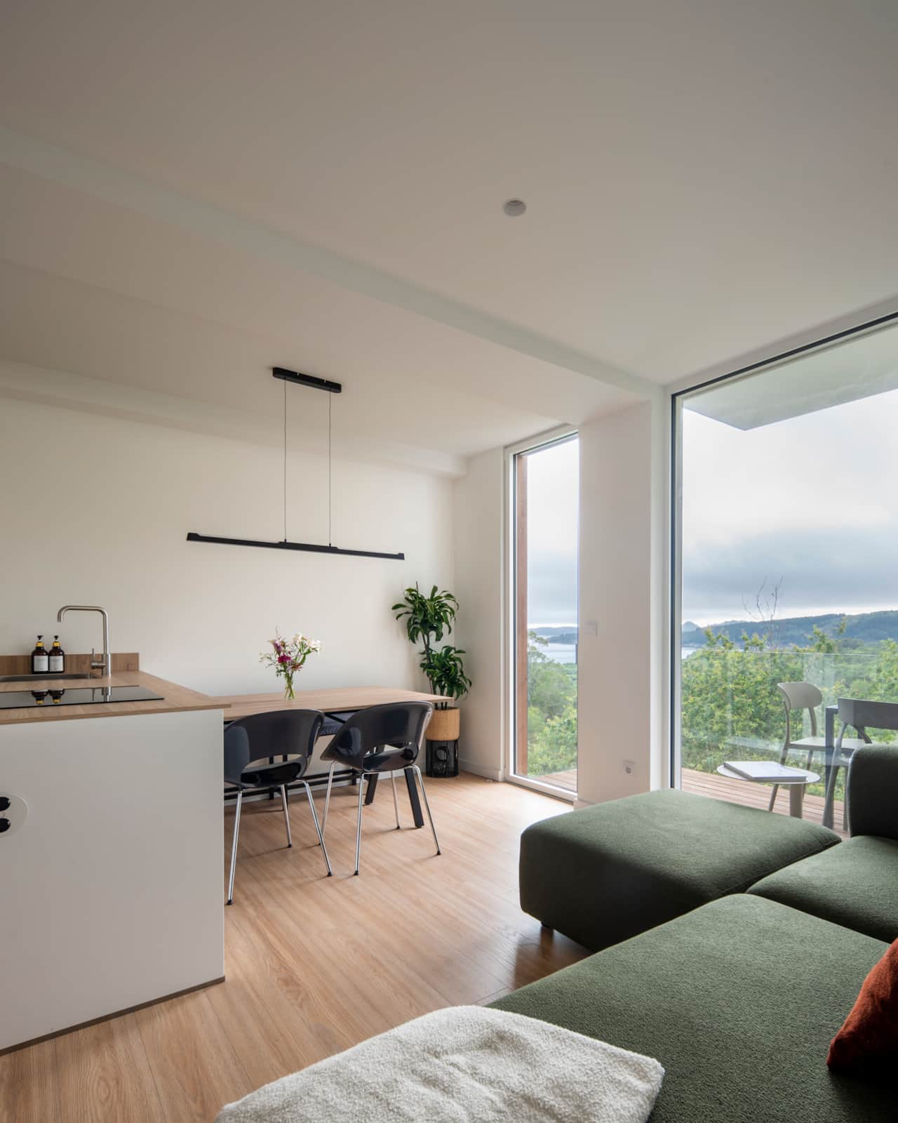 Open living space, modern kitchen, and green views for a peaceful stay.