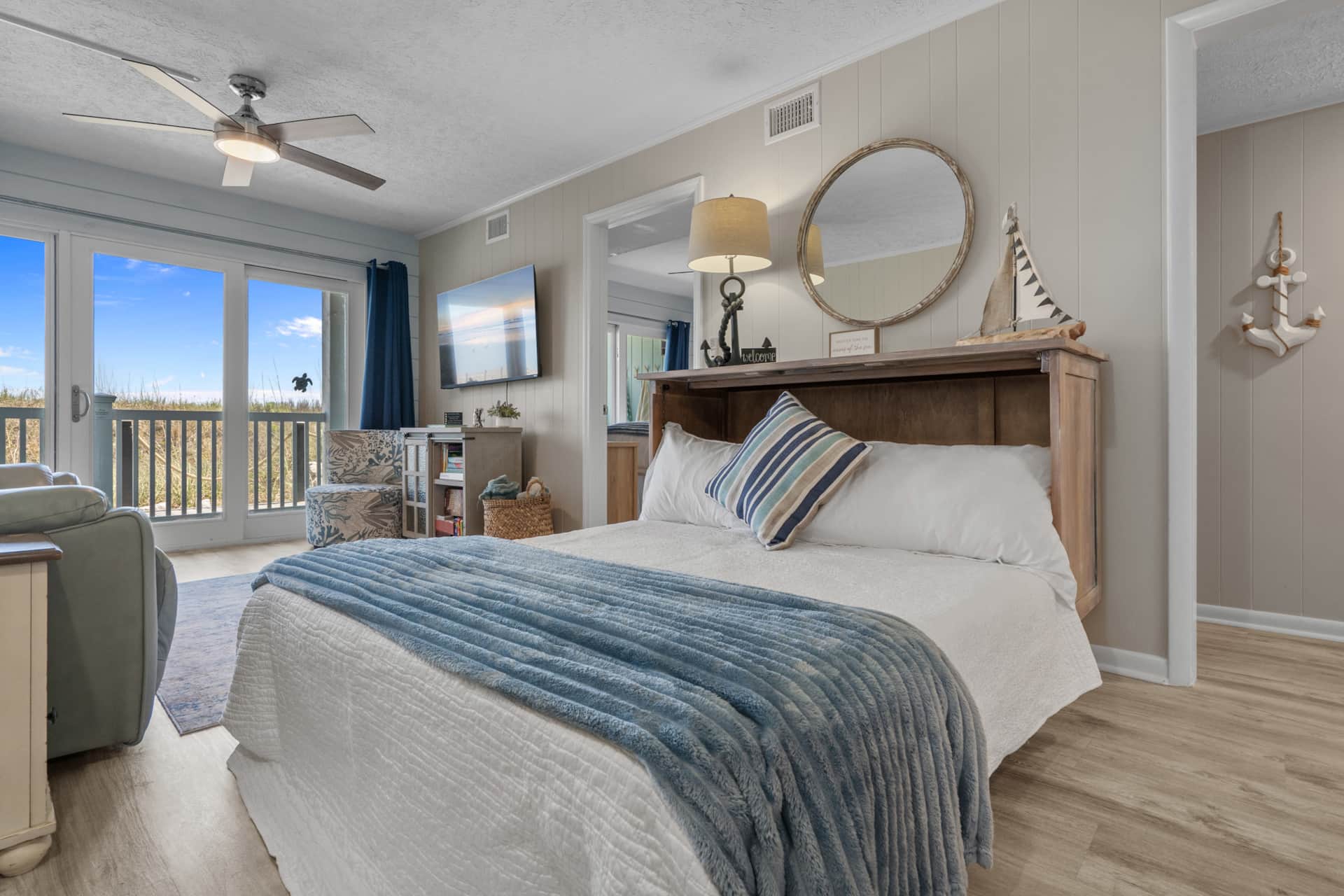 Coastal living room with queen Murphy bed and covered porch access