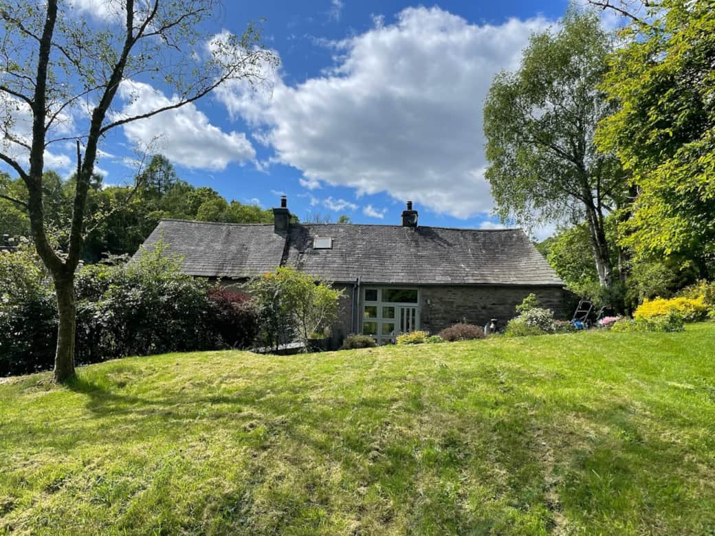 The garden wraps around the barn and the adjacent house (Hunters Fold). This photo shows the barn to the right taken from the rear garden with Hunters Fold to the left screened from the garden and private terrace by mature hedgerow