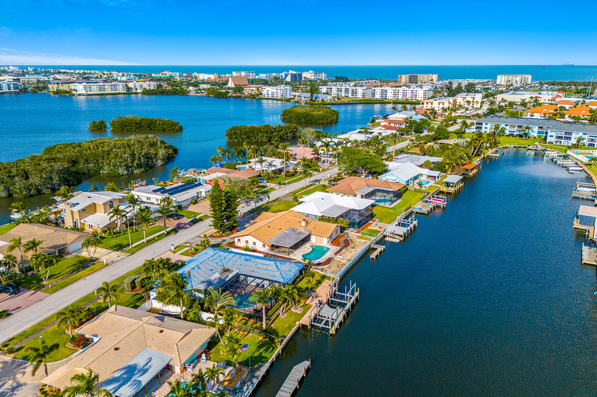Casa de Olas is the blue roof home nestled on a wide deep water canal less than a mile to the beach.