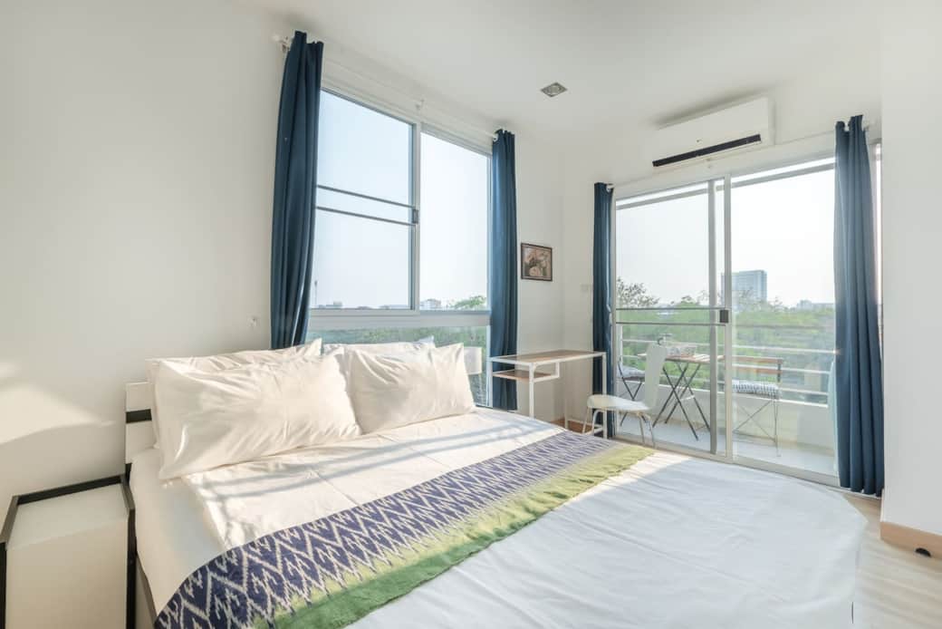 Queen size bed. Bright bedroom connecting to Balcony. 