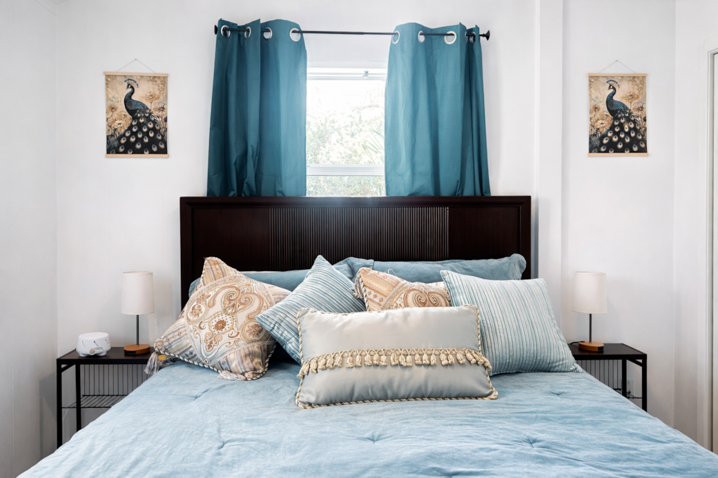 Bright, cozy bedroom with soft linens and calming, stylish touches