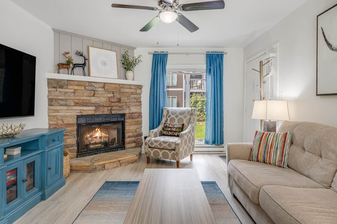 Living room with stone gas fireplace and accent chair