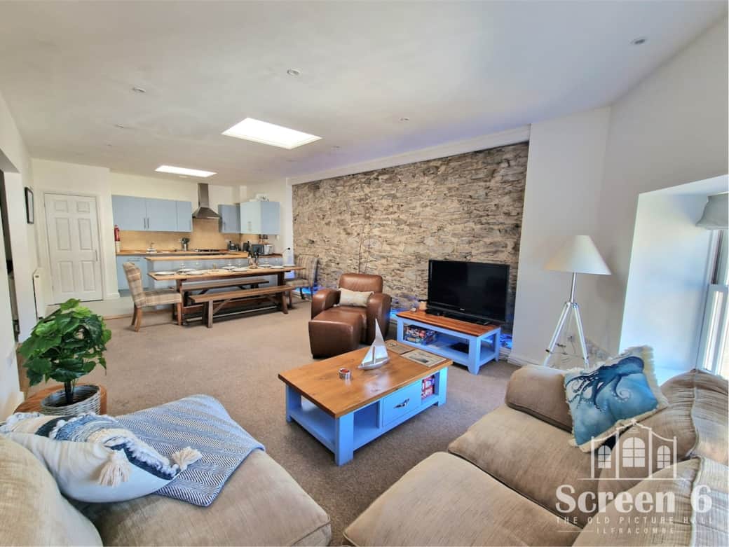 30 ft Living Room with a stunning stone wall