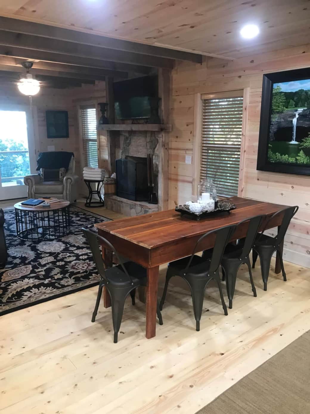 open concept with den and dining and kitchen highlighted by commissioned painting of Desoto Falls