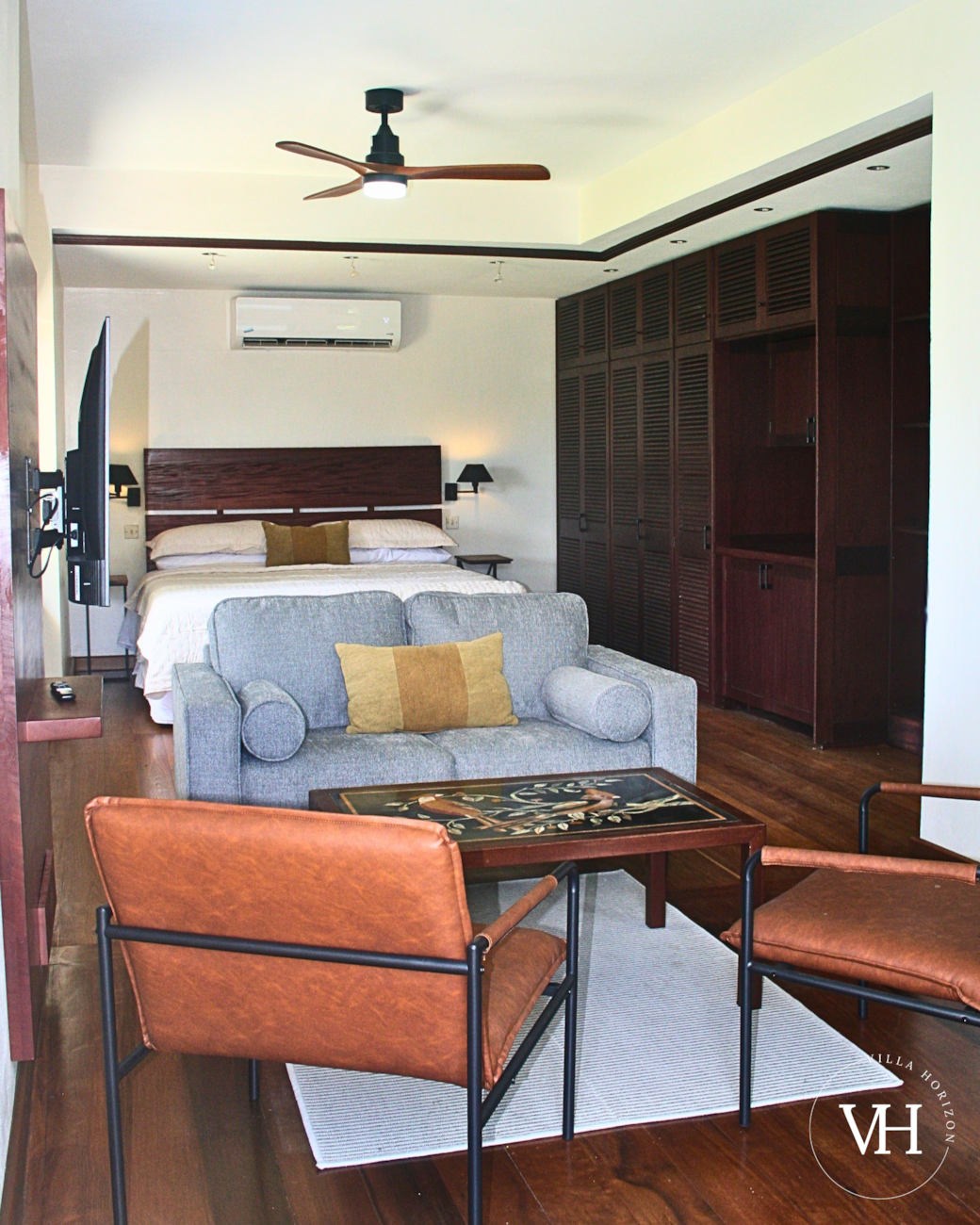 Bougainvillea Studio - Living area with bright windows, Smart TV, comfy seating, and board games. 