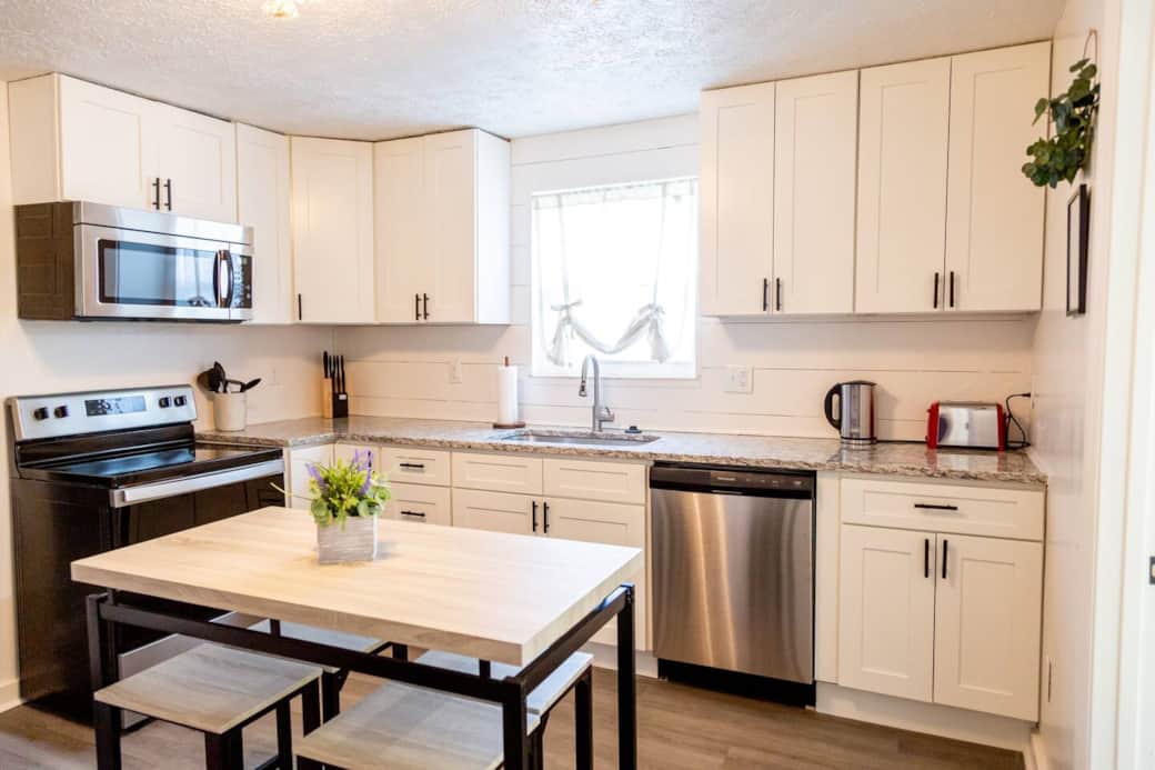 Sage Green Getaway - Light and airy kitchen with stainless steel appliances and granite counter tops. Sage Green Getaway - Light and airy kitchen with stainless steel appliances and granite counter tops.