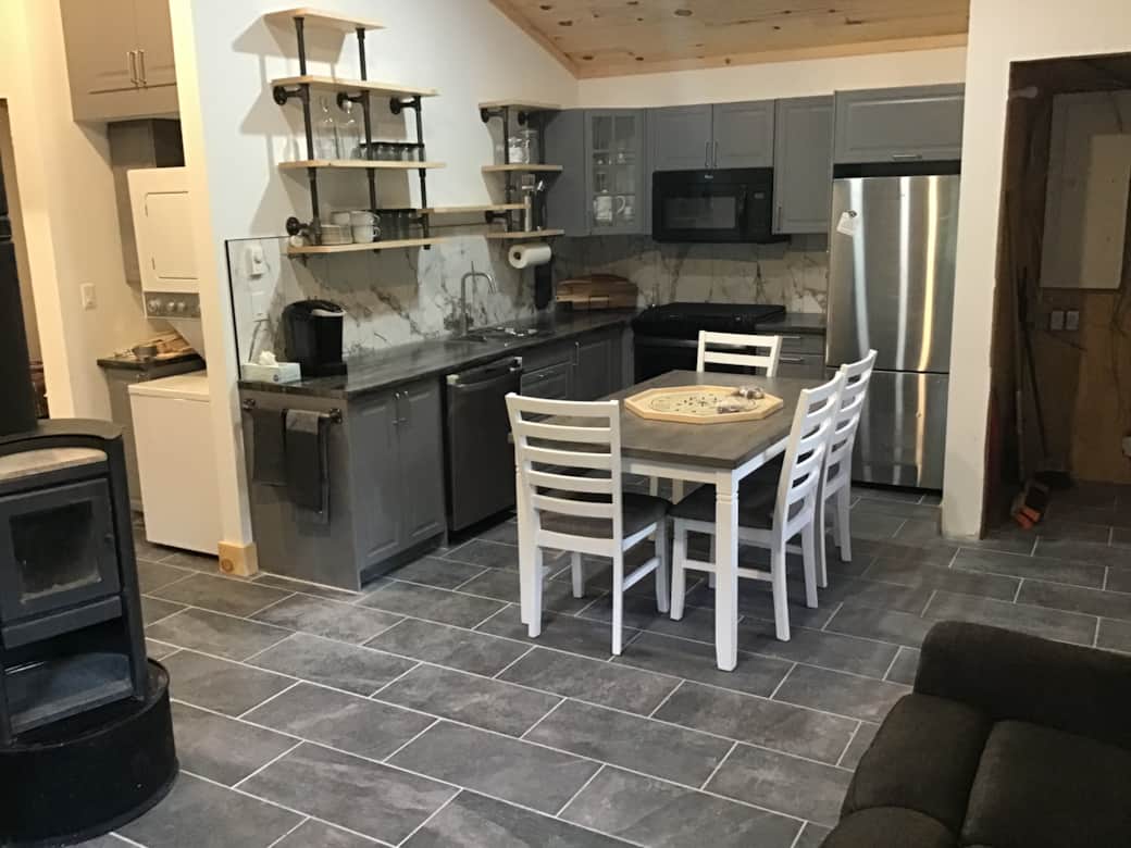 Kitchen with dishwasher, microwave, full size range and fridge. Laundry pair to the left.t 