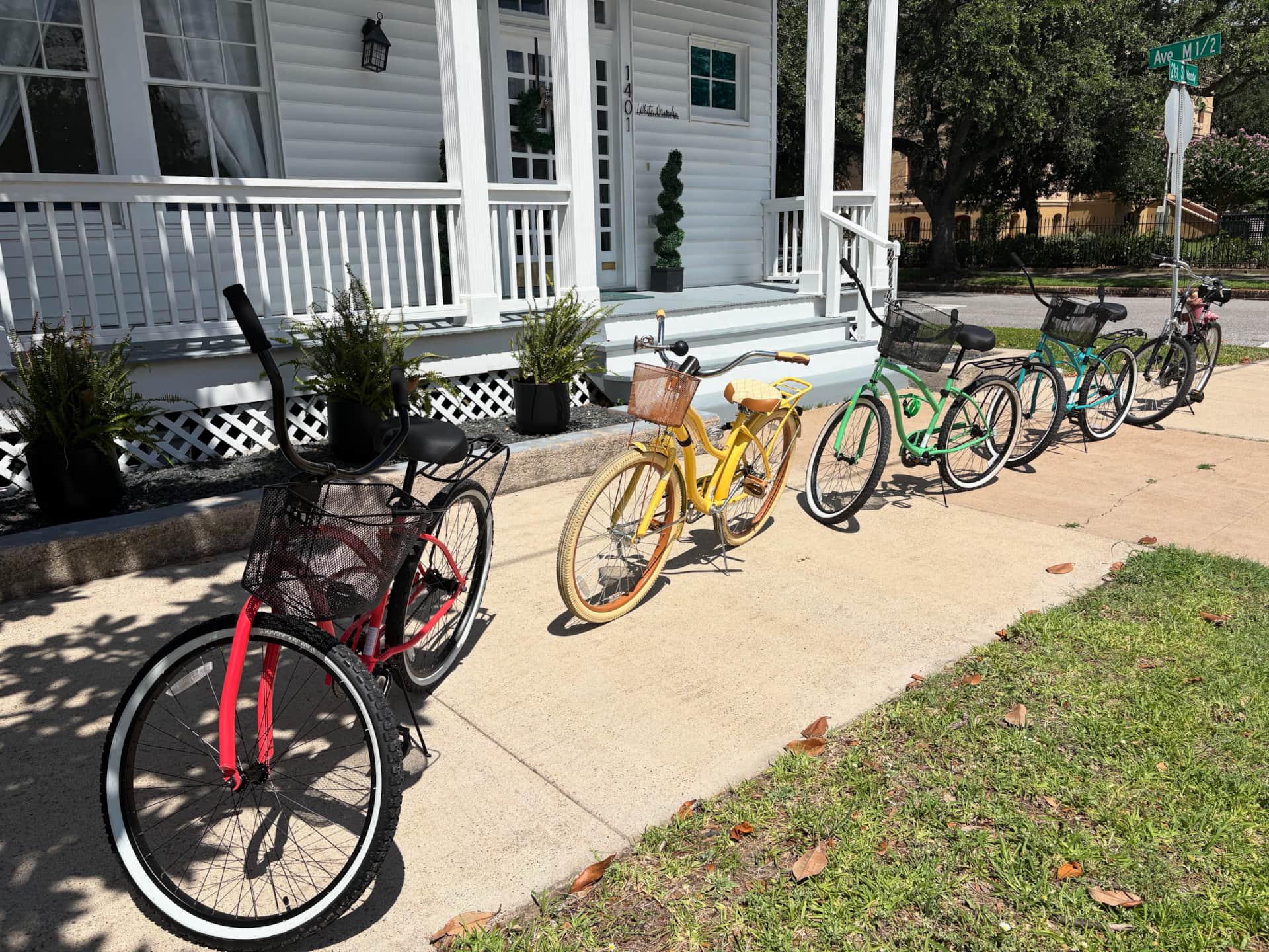 Guest cruiser bikes parked in front of White Magnolia Galveston vacation rental
