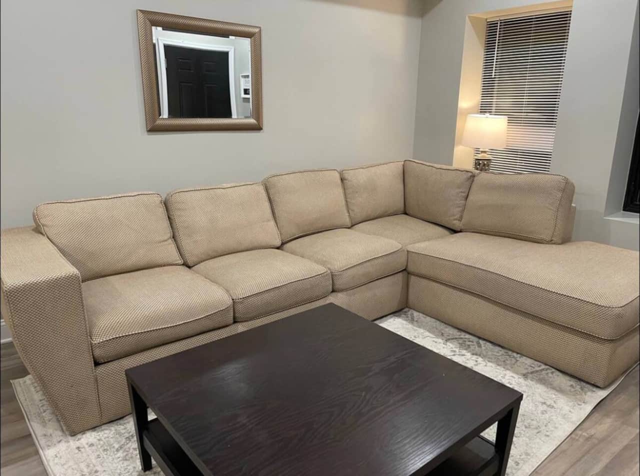 Large living room with sectional and flat screen tv.