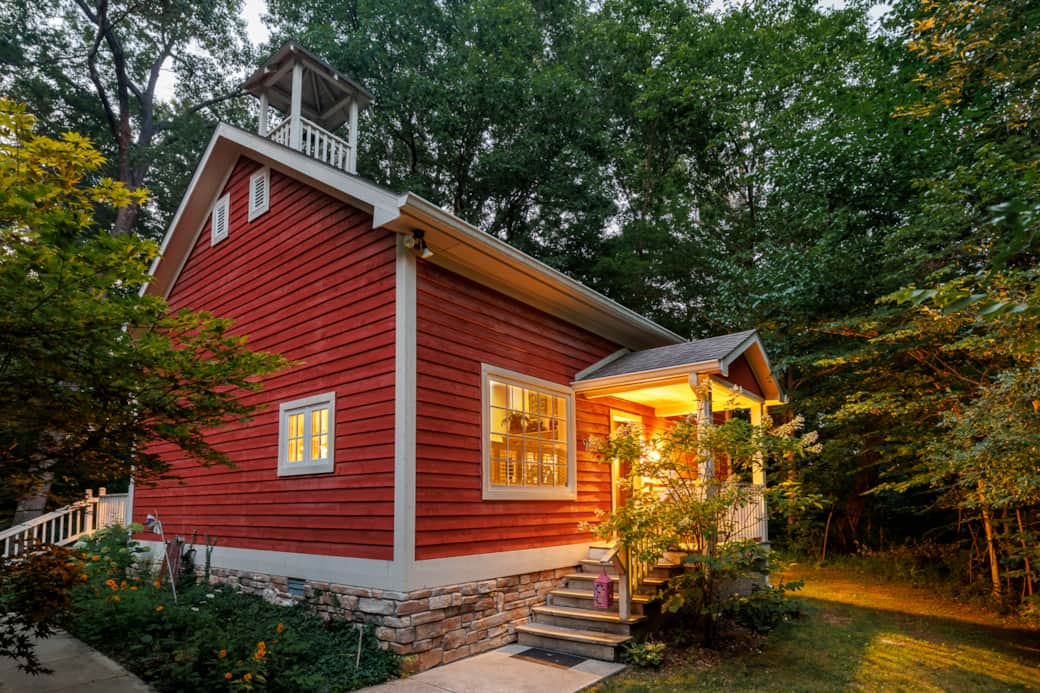 Historic 1891 schoolhouse beneath the trees with a warmly lit private entrance Historic 1891 schoolhouse beneath the trees with a warmly lit private entrance