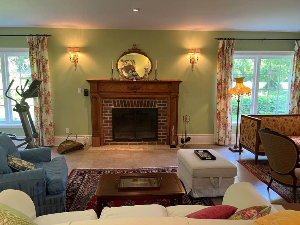 Wood burning Fireplace in this large reception, multi windowed room with multiple book cases & ample room for reading or conversations with 3 separate reading / conversation groupings.