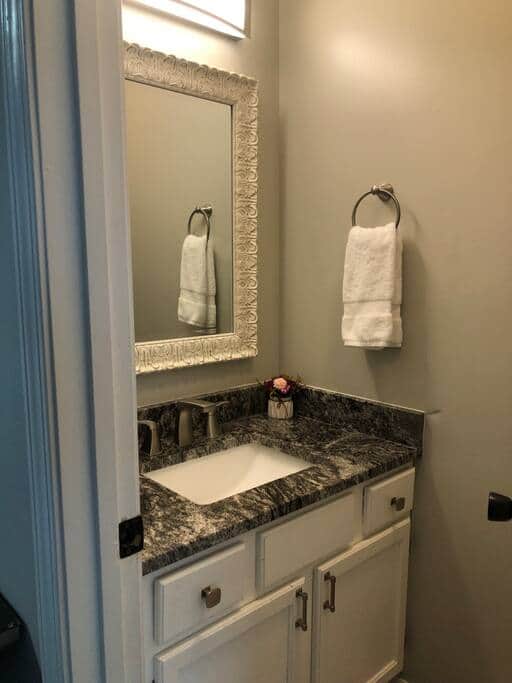Downstairs half bath with a new toilet and sink.