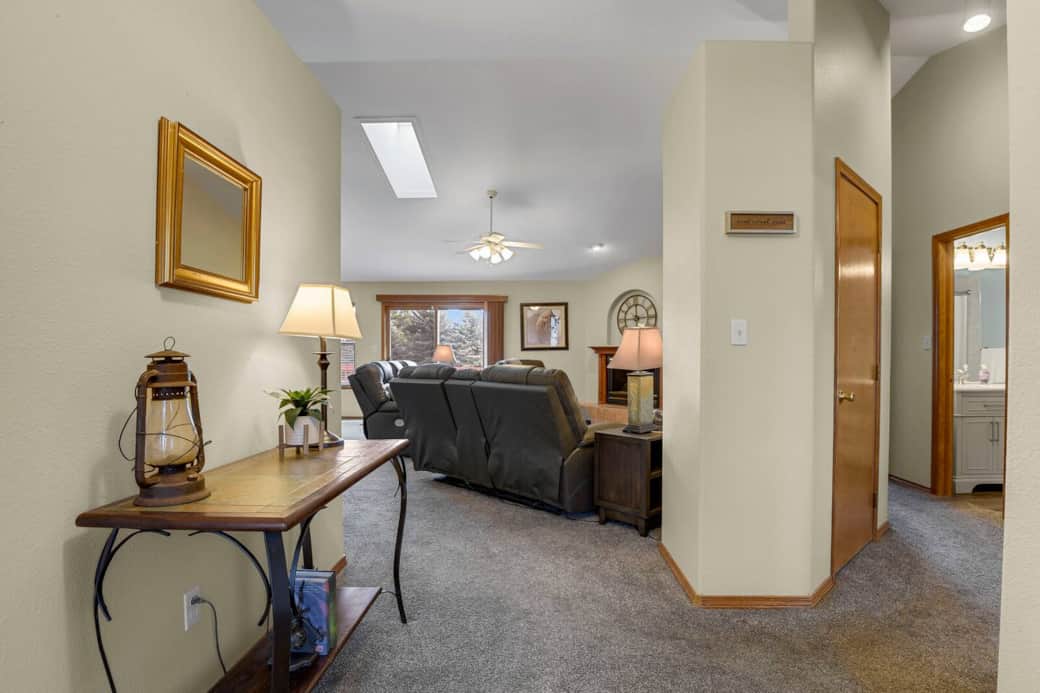 Entrance to living room from front door,  with closets, office, second bathroom and bedroom off of right hallway
