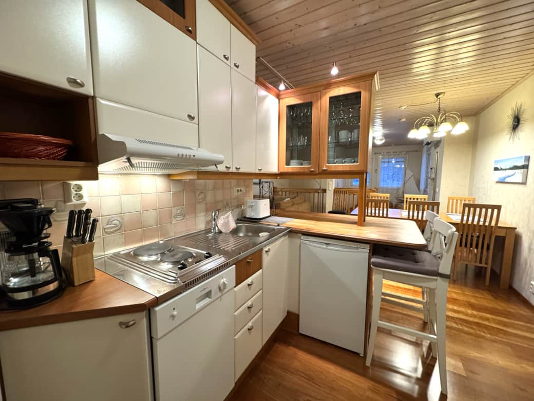 Well equipped kitchen with cooking utensils and refrigerator. Well equipped kitchen with cooking utensils and refrigerator.