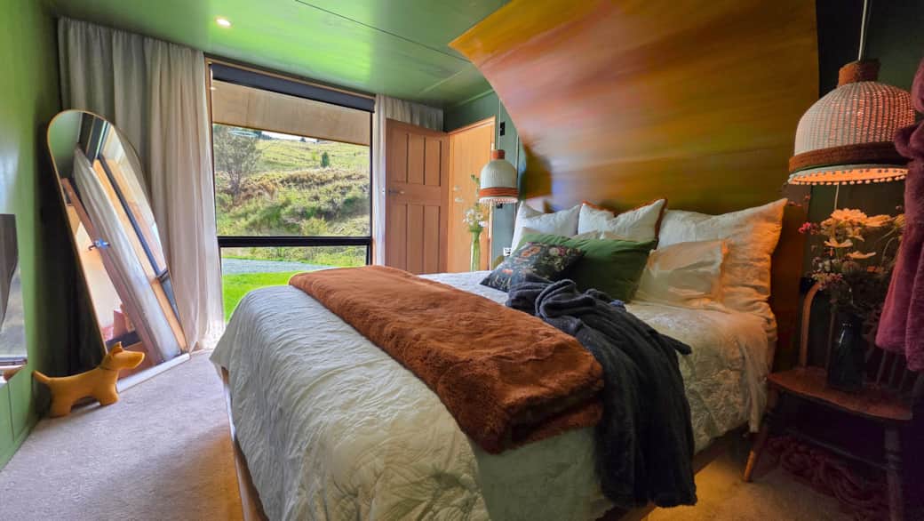 Master bedroom at Cascade Cabin – designer interiors with king bed at Ripples Retreat Waitomo Master bedroom at Cascade Cabin – designer interiors with king bed at Ripples Retreat Waitomo