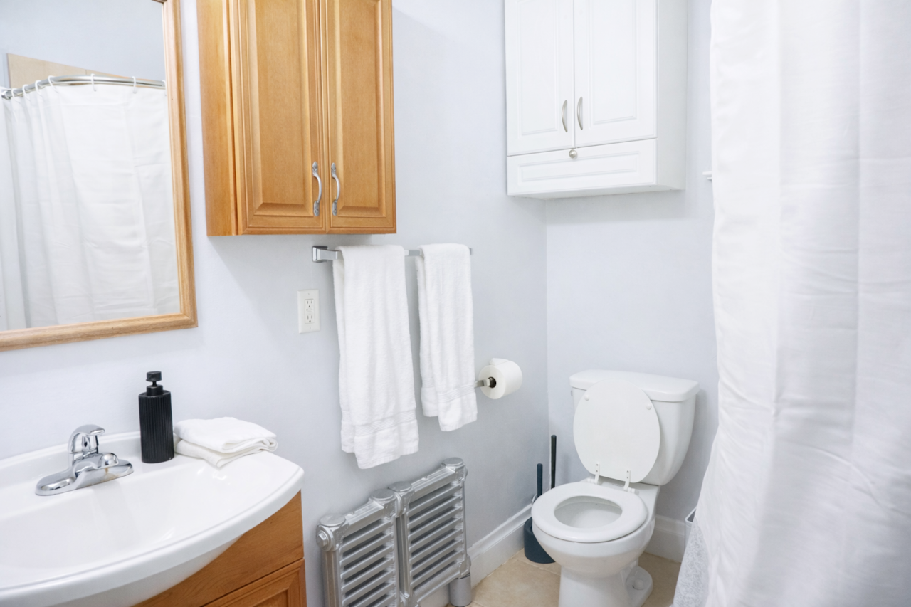 Bright, clean bathroom with fresh towels and essentials provided