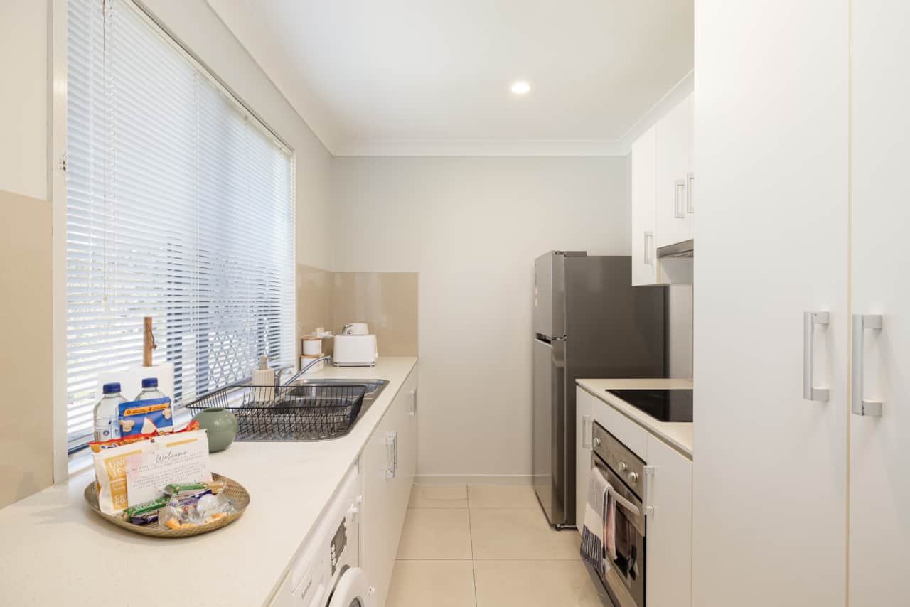 Kitchen: Sleek kitchen with ample storage, modern appliances 