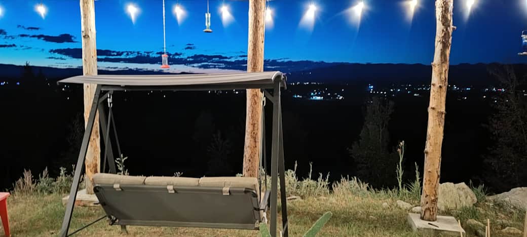 Outdoor swing and valley view at dusk