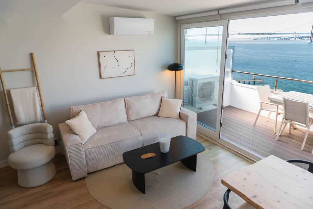 The bright, air-conditioned living room. That bridge view? It's real, and it's all yours.