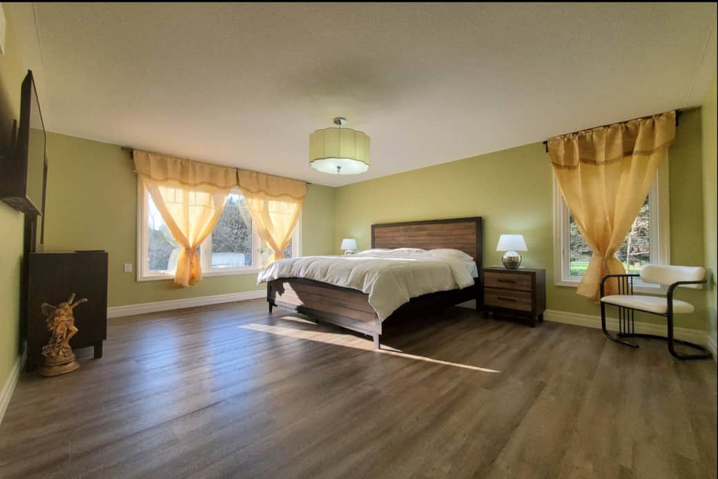 Lakeview master bedroom with king bed at BizLodge in Prince Edward County