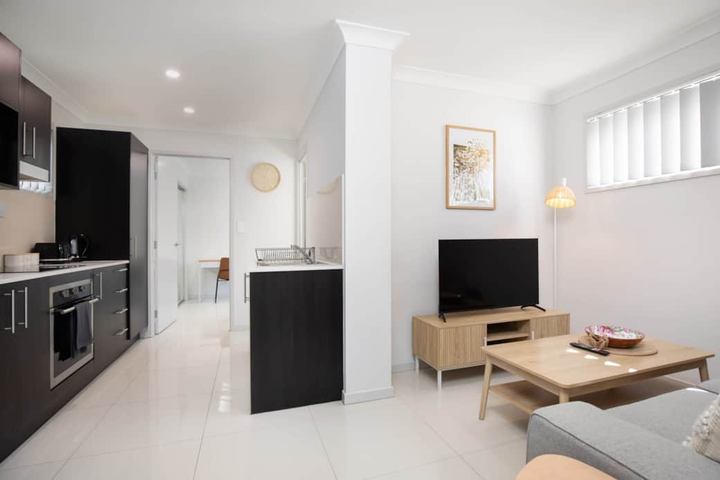 Living Area: Bright living space with comfortable seating and TV 