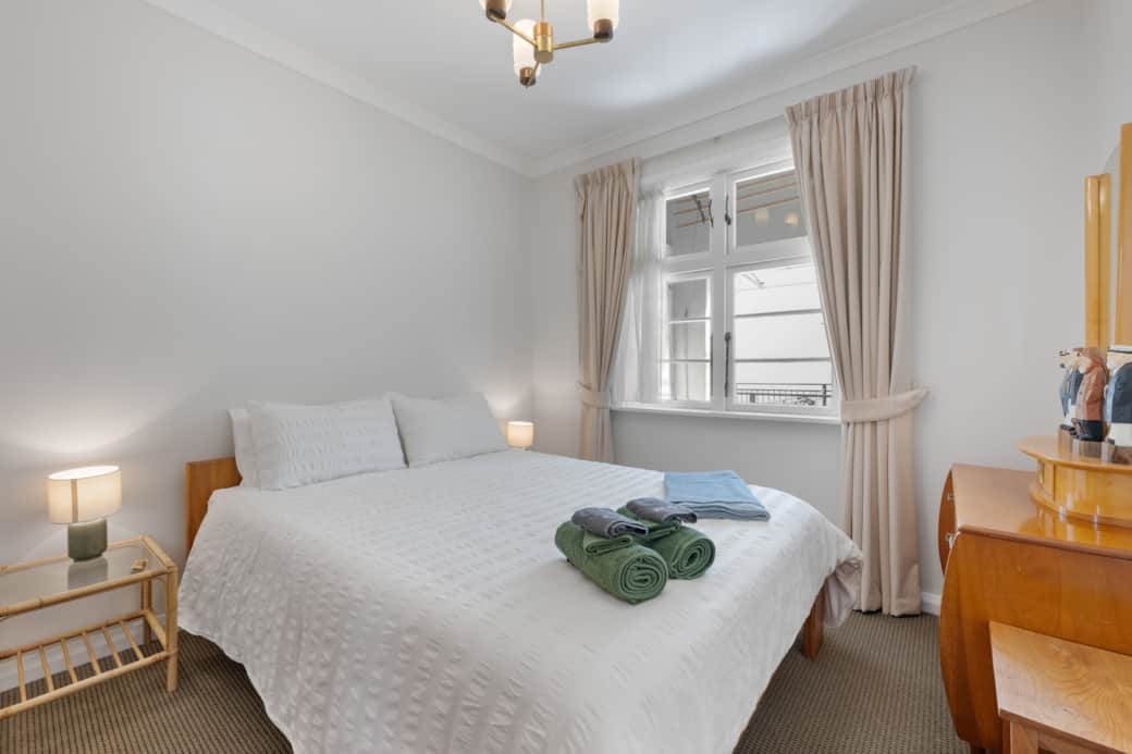 The second bedroom features premium cotton linens and a plush mattress.