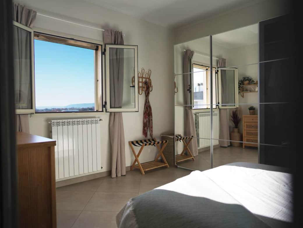 The master bedroom is bright & peaceful. It features a comfortable double bed, a spacious wardrobe, full-length mirror. The window is fitted with a mosquito net — and offers beautiful panoramic mountain views to wake up to each morning.