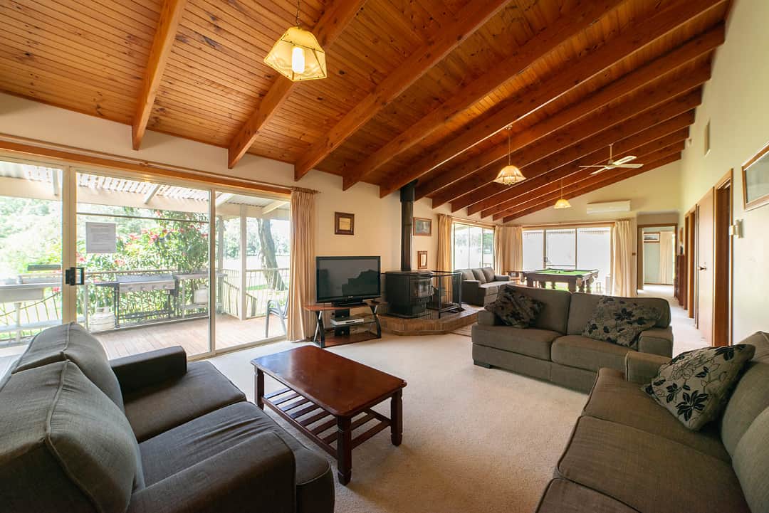 Enjoy the cozy living area with a wood fire, ideal for both warmth and ambiance.