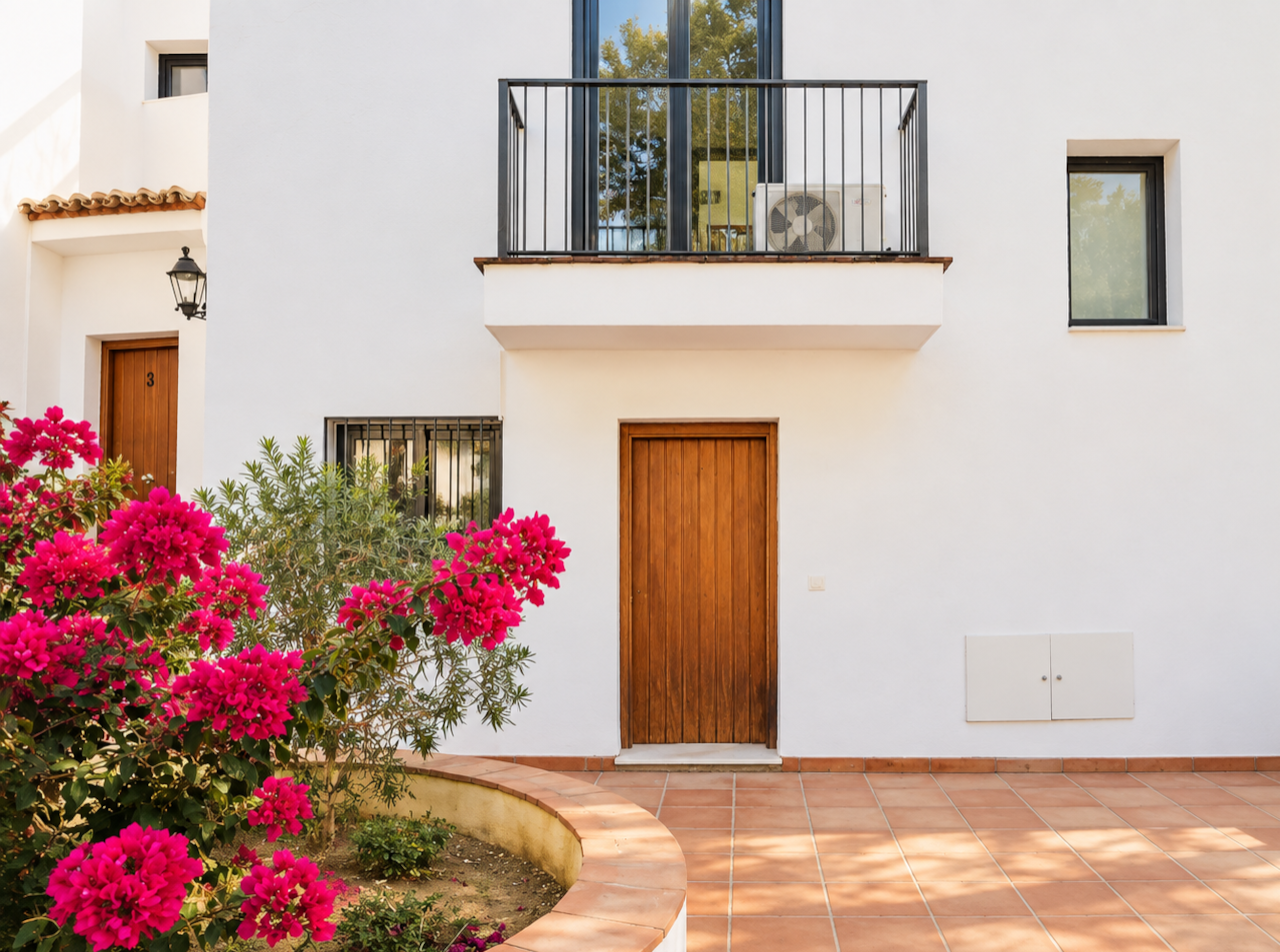 Front entrance framed by colourful bougainvillea