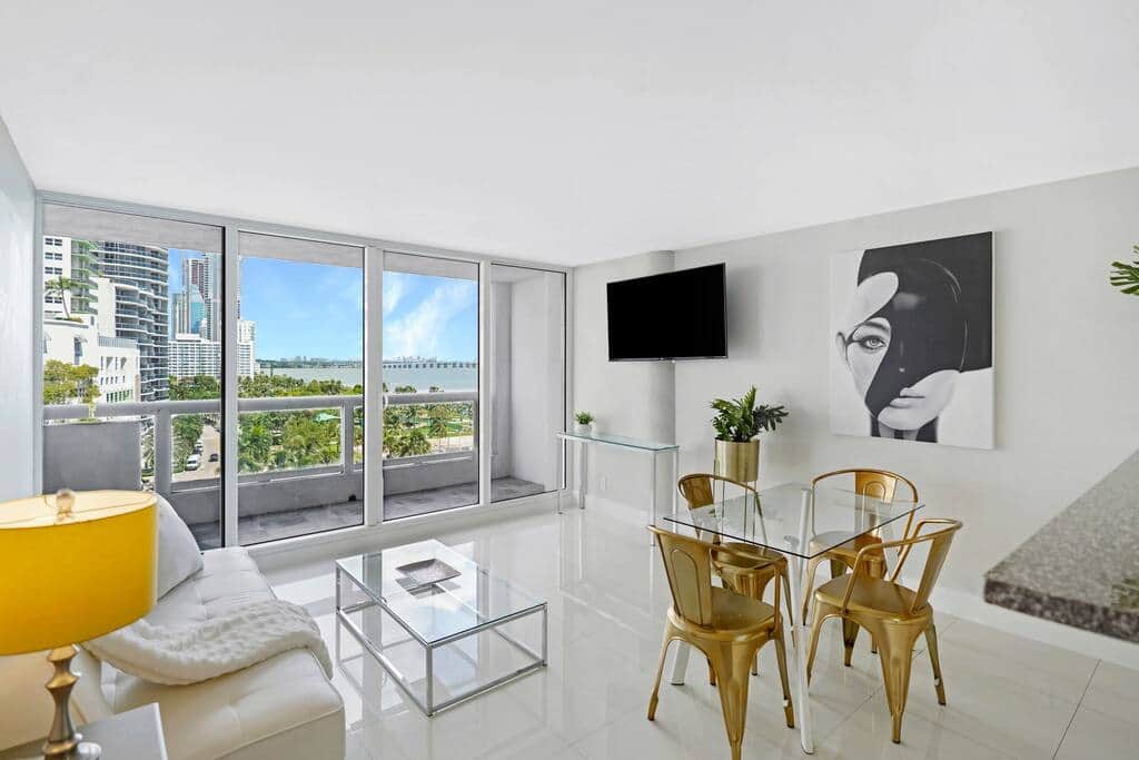Living/dining area, Tv, balcony access, views of Biscayne Bay and Margaret Pace Park