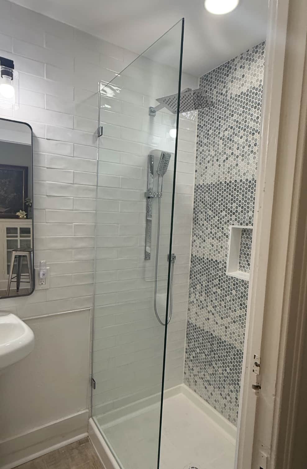 Downstairs bathroom shower with modern tile and fixtures at White Magnolia Galveston