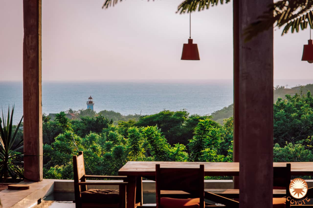 Open-air dining terrace framed by tropical gardens