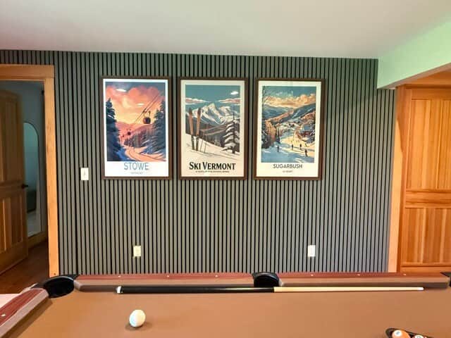 Game room with pool table and vintage Vermont ski art—perfect for friendly competition and après-ski vibes.