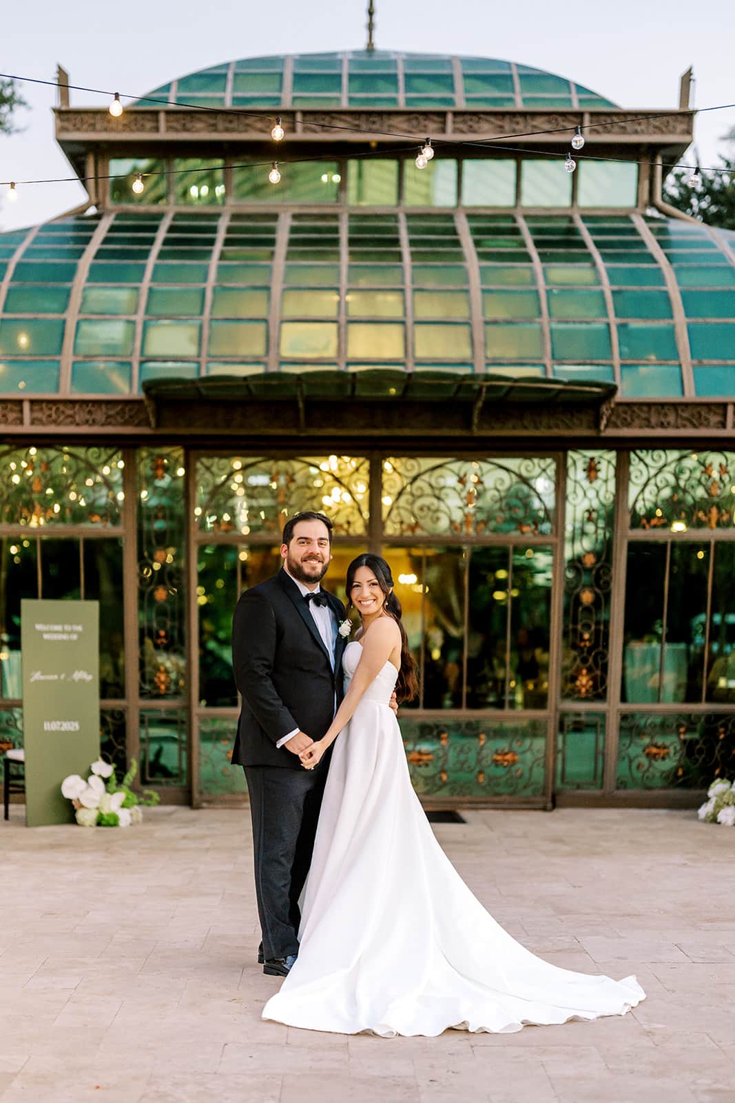 Newlywed couple standing in front of the Bryan Museum atrium in Galveston, Texas