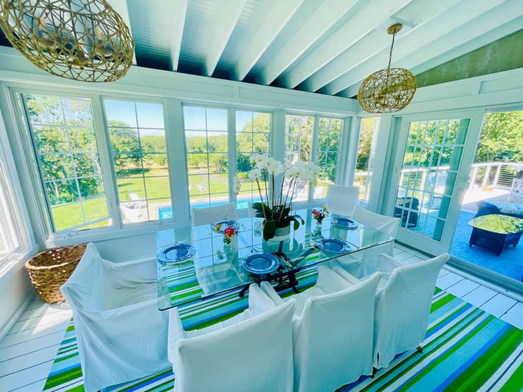 The window-wrapped sunroom is the perfect place for breakfast, lunch and dinner.