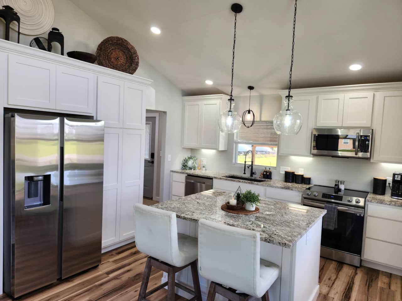 Kitchen with granite counter tops is completely equipped with all the essentials for cooking.