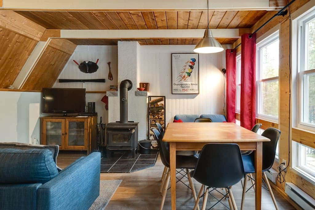 Living room with wood fireplace and dining table Living room with wood fireplace and dining table