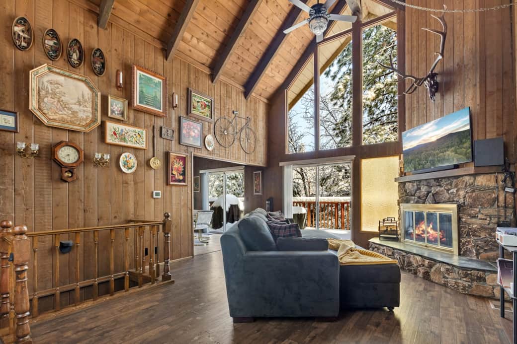 Enjoy the vintage art accented wall, two overhead crystal ceiling fans and the sliding doors which provide access to the front deck Enjoy the vintage art accented wall, two overhead crystal ceiling fans and the sliding doors which provide access to the front deck