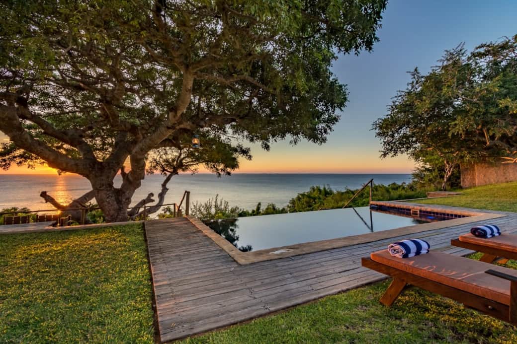 Infinity pool overlooking the ocean at sunset Infinity pool overlooking the ocean at sunset