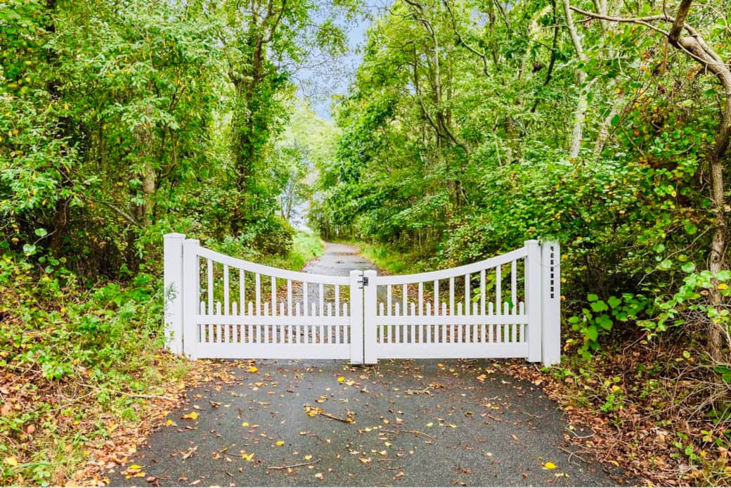 Thru the white-gated entrance is an impressive 1,200-foot-long private driveway.