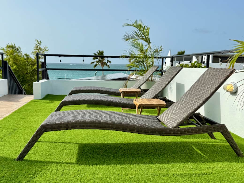 Shared ocean-view rooftop with lounge chairs and sea breeze