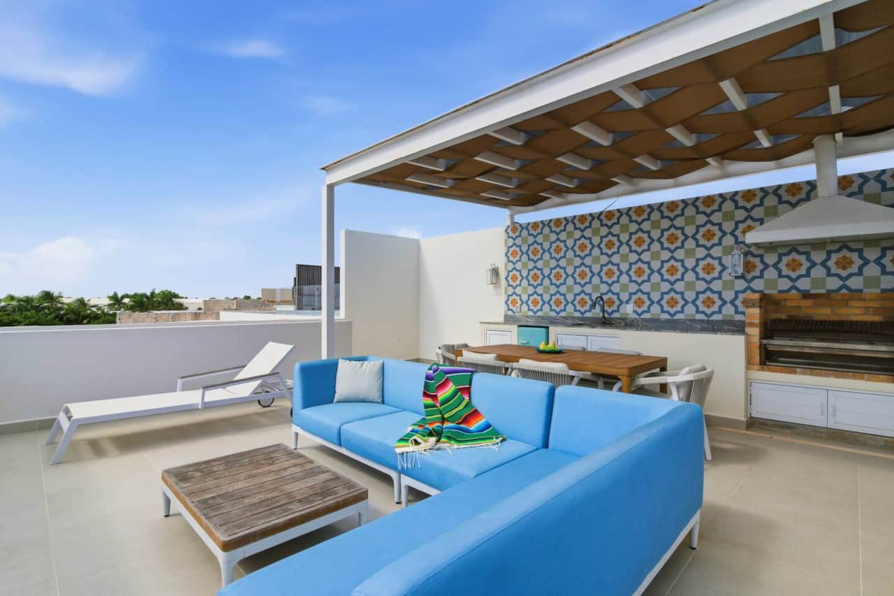 Your private rooftop terrace with Caribbean Sea views, perfect for relaxing. Enjoy outdoor lounge seating and a sun lounger, gather at the dining table for six, fire up the BBQ grill, enjoy drinks from the mini fridge, and unwind under soft lights.